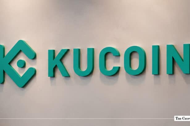 Green KuCoin logo and wordmark mounted on a off-white corporate wall.