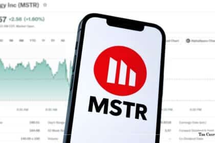 Smartphone displaying the MicroStrategy (MSTR) logo in front of a stock market price chart.