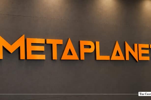 Orange 3D Metaplanet logo mounted on a dark grey corporate office wall
