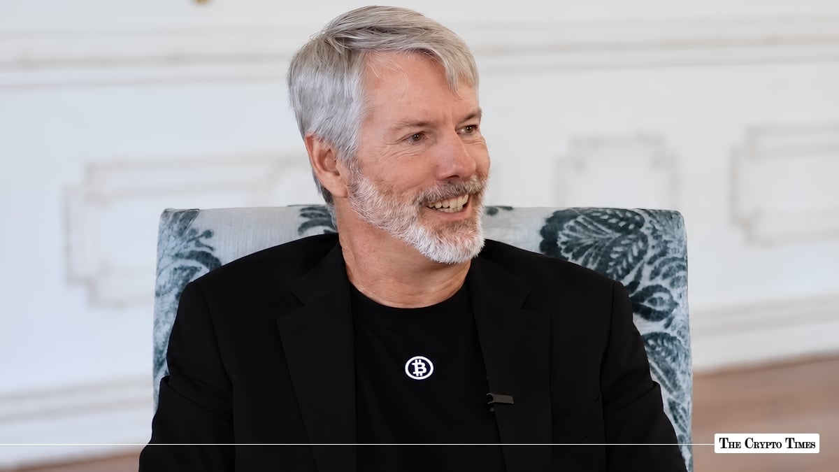 Michael Saylor wearing a Bitcoin t-shirt and smiling during an interview