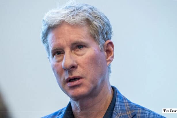 Close-up portrait of Ripple co-founder and executive chairman Chris Larsen wearing a blue plaid jacket speaking
