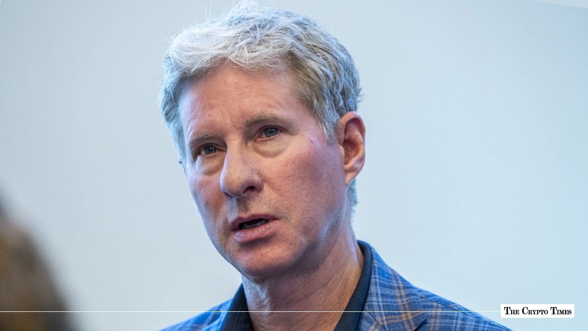 Close-up portrait of Ripple co-founder and executive chairman Chris Larsen wearing a blue plaid jacket speaking