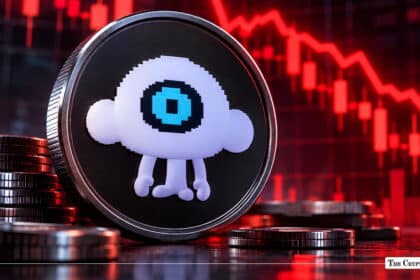 A physical token featuring the Puffer Finance mascot set against a red declining market chart.
