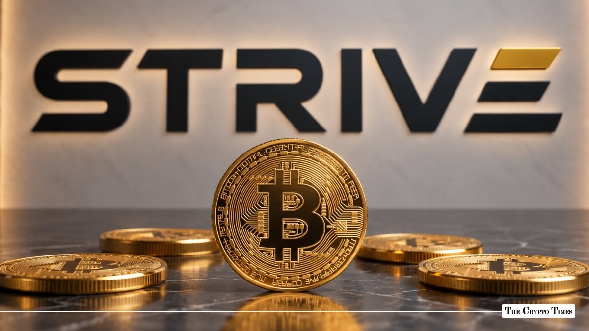 Physical Bitcoin token standing on a dark marble surface in front of the Strive corporate logo