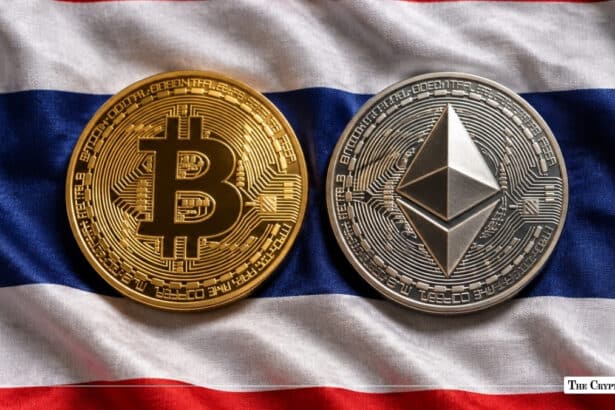 Physical gold Bitcoin and silver Ethereum coins lying on the national flag of Thailand