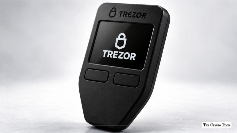 Black Trezor hardware cryptocurrency wallet with display screen showing the Trezor logo.