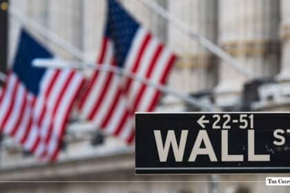 Wall Street sign with American flags in the background