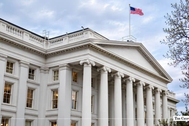 Exterior view of the United States Treasury Building with an American flag flying on the roof.