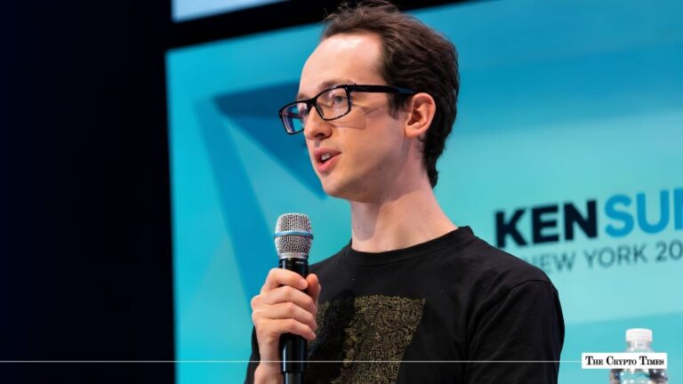 Uniswap founder Hayden Adams holding a microphone while speaking at a conference.