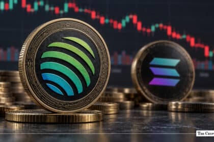 Physical Jupiter (JUP) token coin standing alongside a Solana (SOL) coin with a financial price candlestick chart in the background