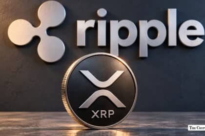 Physical XRP coin displayed in front of a metallic Ripple logo